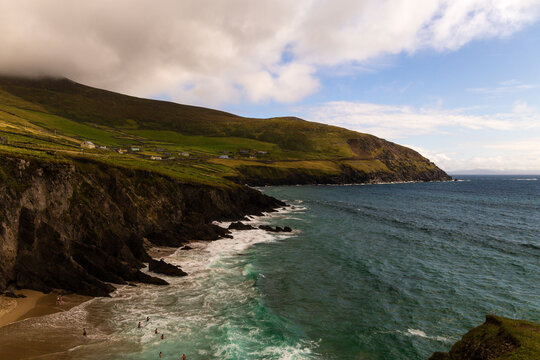 Wild Atlantic Way Dunmore Head beach with wild and windy waves for great fun and surfing. Family fun time secluded with beautiful coloured waters and white sand beach. Near Dunquin Head, Kerry Ireland