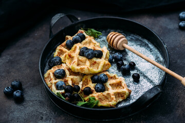 Belgian sweet waffles with blueberries, raspberries and honey