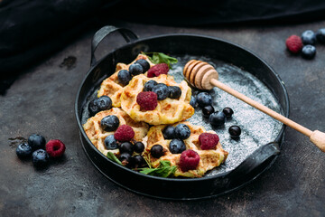 Belgian sweet waffles with blueberries, raspberries and honey