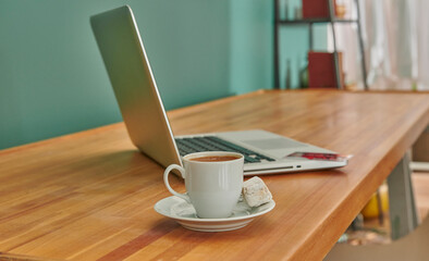 Turkish coffee on the wooden desk, working table, credit card and laptop style.