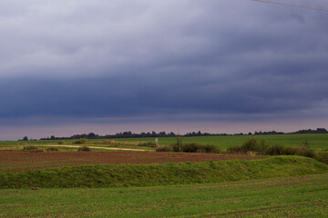 Obraz premium Dark clouds over the fields. Countryside landscape.