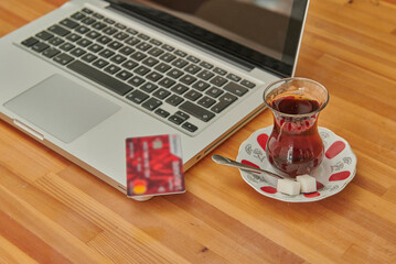Turkish tea on the desk, tablet smart phone and laptop style with shopping credit card concept.