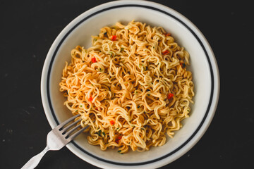Noodles and vegetables on a plate. horizontal view from above