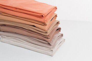 Rolls of bright colored fabric on a white background.