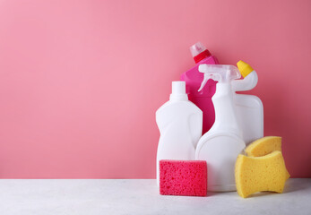 Chemical cleaning supplies on pink background