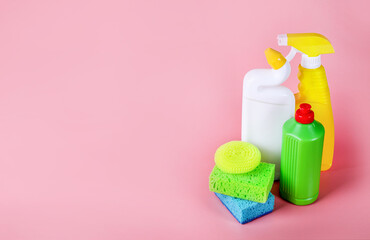 Chemical cleaning supplies on pink background