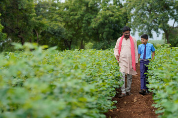 Indian farmer with his son at agriculture field