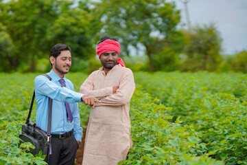 Indian farmer Discussing with agronomist at Farm and collecting some information