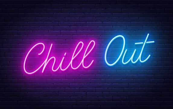 Chill Out neon lettering on brick wall background.
