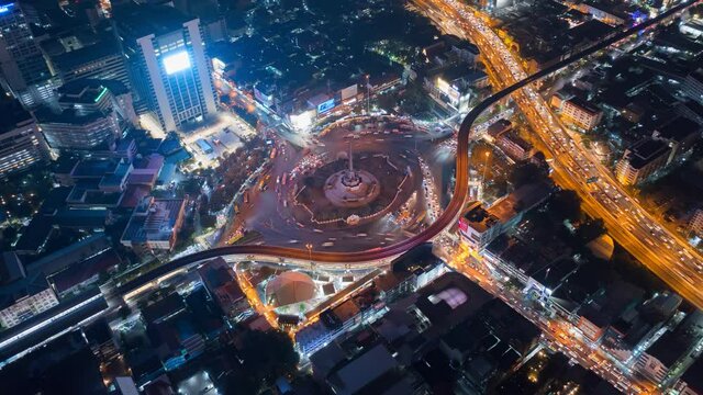 Aerial view of huge roundabout and traffic lights at Victory Monument during the night time. Landmark of Bangkok, Thailand
