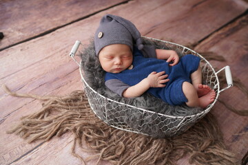 Sleeping newborn boy in the first days of life. Newborn photo session.