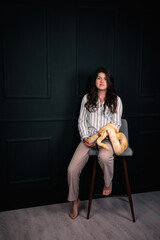 Nice girl with a snake in her hands on a black background.