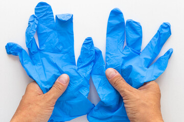 Top view of woman hands holding medical blue gloves