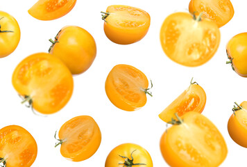 Fresh ripe yellow tomatoes falling on white background