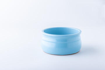 Blue clay cup on a white background.