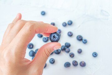 Hand hold Harvest summer jam ingredient organic bio tasty blueberry healthy natural purple fruit berry for sweet dessert vitamin antioxidant snack with fresh wet water drop