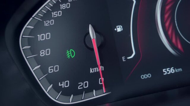 Car speedometer arrow is moving from 0 to 100. Engine starts