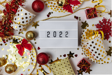 Happy new year 2021 table light box with party cup, party blower, tinsel,confetti. Fun Celebration holiday party time table flat lay invitation or greeting card. New year eve concept on white.