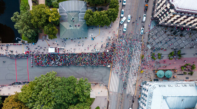 Hundreds of runners getting ready for the  marathon. Starting Riga marathon. Aerial top-down view from drone.