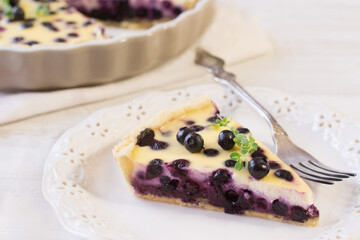 Piece of blueberry cake on wooden table