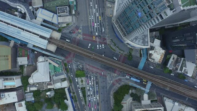 Time lapse of aerial view of Asoke intersection or junction with cars traffic, Bangkok Downtown. Thailand. Financial district in smart urban city and technology concept
