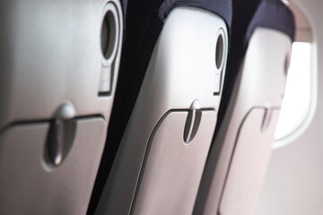 Aisle of airplane seat backs in economy class