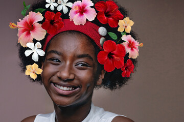 Portrait of dark-skinned girl with Blooming Hibiscus flowers on her head, beauty summer teen girl