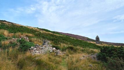 Fototapeta na wymiar Badbea Highland Clearances village ruins on the Caithness coast in the Highlands with the memorial to John Sutherland Badbea
