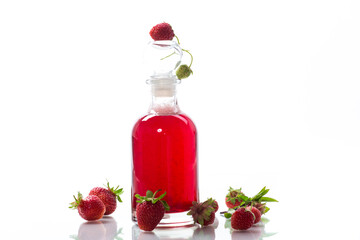 sweet cooked strawberry syrup in a glass decanter