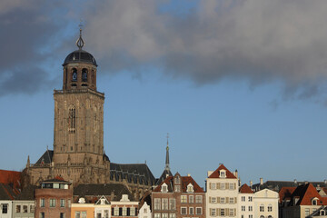 Naklejka na ściany i meble The facades of beautiful old buildings and the tower of the Great Church in the city of Deventer, The Netherlands