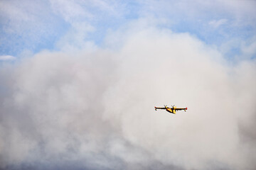 Hydroplane amidst ash clouds working to extinguish a forest fire