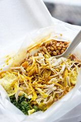 porridge with shredded chicken toping in styrofoam packaging