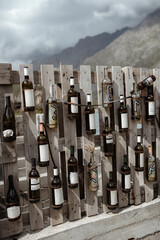 Wine bottles at exhibition with the cloudy sky on the background