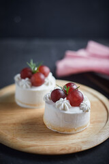 Cake with fresh fruits. Grapes on the cake.