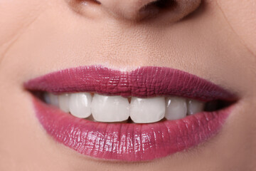 Fototapeta premium Closeup of woman smile with burgundy lips painted with lipstick