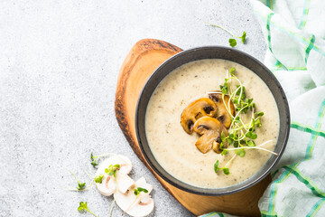 Mushroom Soup on light stone table. Champignon cream soup. Top view with copy space.