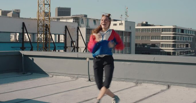 funny woman dancing on rooftop celebrating enjoying silly dance having fun crazy dancer girl in city