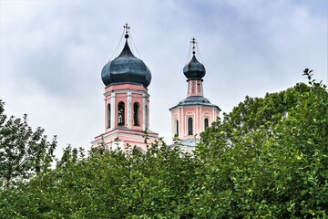 Fototapeta na wymiar Russia, Valdai, August 2021. Domes of an Orthodox church among the greenery.