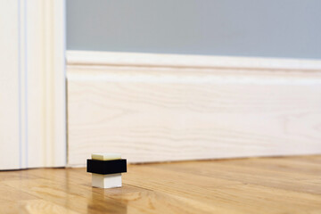 Modern door stop on the floor. The door stopper.
