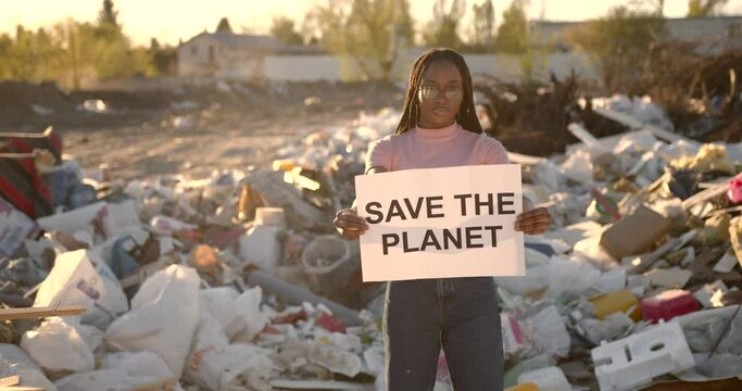 African American woman holding save the planet sign