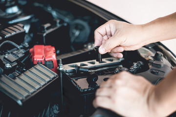 A man hold and open cap of add battery for add distilled : maintenance and inspections for extended service life battery of car