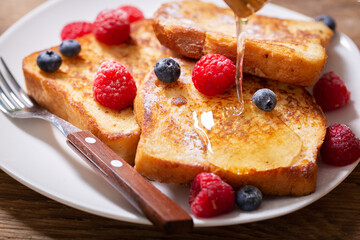 plate of french toasts with fresh berries