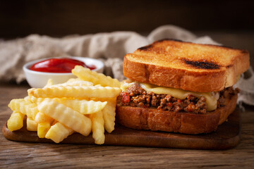 sloppy joe sandwich with ground meat and french fries
