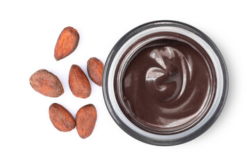 Cacao beans and chocolate cream in glass jar isolated on white background. Top view. Flat lay.