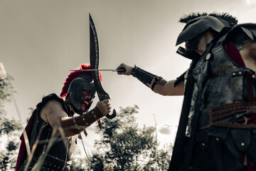 Battle with swords between two ancient warriors on meadow.