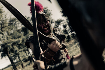 Battle with swords between two ancient warriors on meadow.