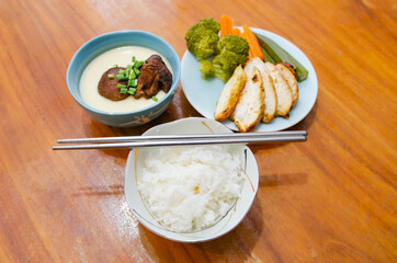 Diet menu for weight loss. Grilled chicken, poached eggs and boiled vegetables.