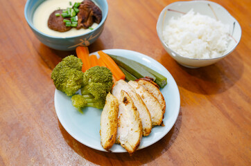 Diet menu for weight loss. Grilled chicken, poached eggs and boiled vegetables.