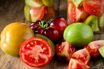 Fresh and tinned tomatoes close up look