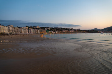The bay of San Sebastian, Spain, during the night, with calm ocean waters on the beach and little waves. With copy-space.